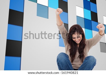 Composite image of pretty brunette cheering while using laptop