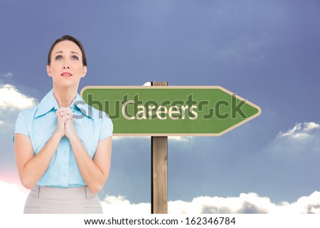 Composite image of troubled young businesswoman praying while posing