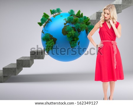 Composite image of elegant blonde standing hand on hip in red dress