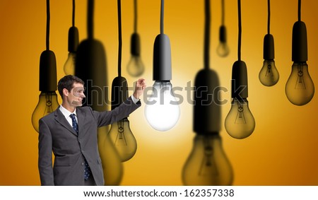 Composite image of smiling businessman holding something up in the air