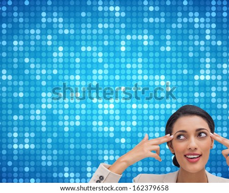 Composite image of confident young businesswoman pointing her head with her fingers