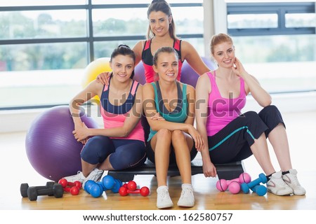 Portrait of a group of fitness class at a bright exercise room