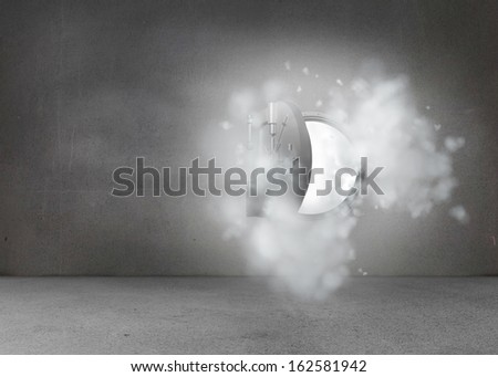 Open safe in dust cloud on grey wall