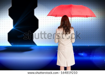 Composite image of businesswoman standing back to camera holding red umbrella
