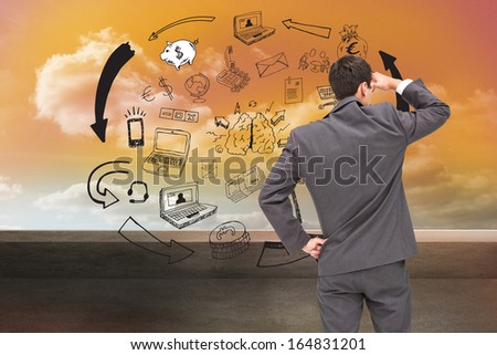 Composite image of businessman standing hand on hip peering