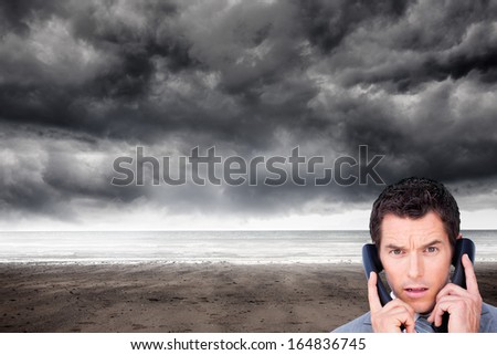 Composite image of angry businessman on the phone