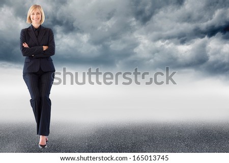 Composite image of attractive friendly businesswoman smiling at the camera in a meeting