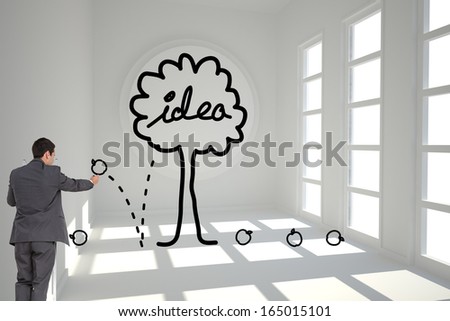 Composite image of businessman standing on ladder writing