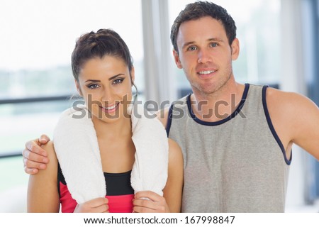 Close-up portrait of a fit young couple in a bright exercise room
