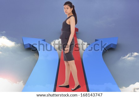 Asian businesswoman walking against red arrow pointing down