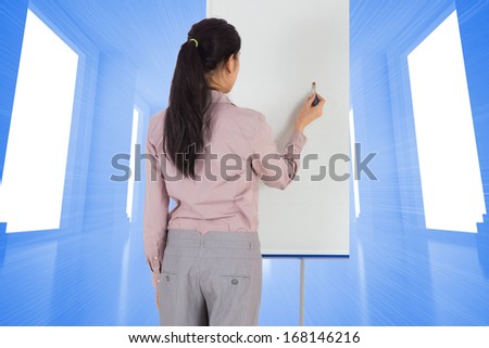 Businesswoman painting on an easel against bright blue room with windows