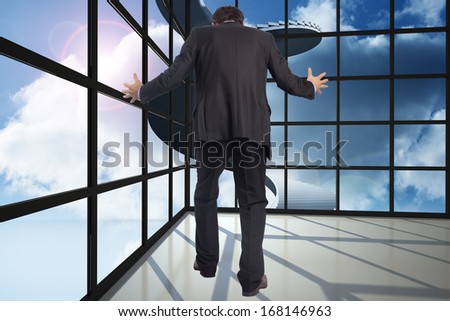Gesturing businessman against staircase in blue sky seen through window