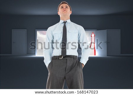 Serious businessman standing with hands in pockets against doors opening to show red arrow and sky