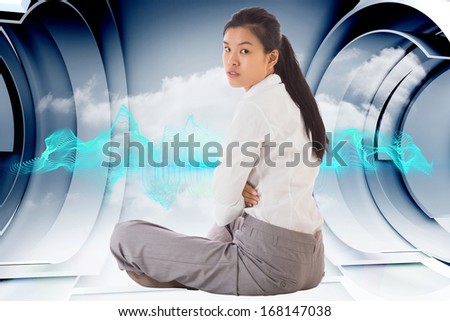 Businesswoman sitting cross legged frowning against abstract blue design on clouds in structure