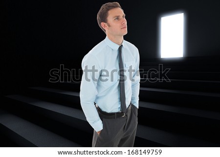Serious businessman with hands in pockets against steps leading to light in the darkness