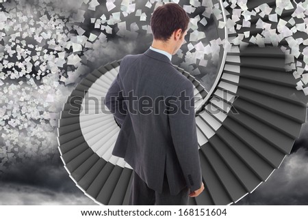 Businessman standing with hand on hip against winding staircase in the sky with flying papers