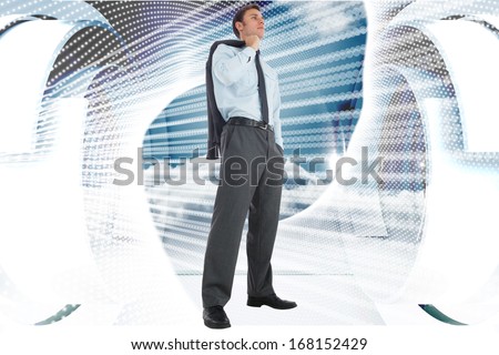 Serious businessman holding his jacket against abstract white design on blue and white