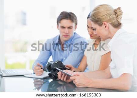 Young businessman and women working together at office desk