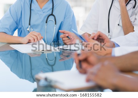 Mid section group of young doctors in a meeting at hospital