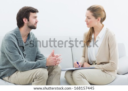 Side view of a young man in meeting with a financial adviser at home