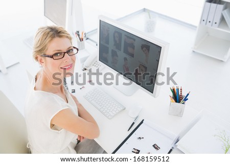 High Angle Portrait Of A Female Photo Editor Working On Computer In A Bright Office