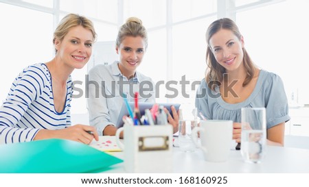 Group of artists working on designs in a bright office