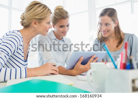Group of artists using digital tablet in a bright office