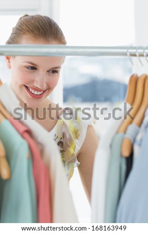Close-up of a beautiful female customer selecting clothes at store