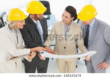 Engineer co-workers discussing a project in the office