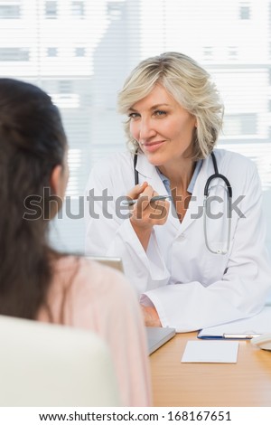 Friendly female doctor in conversation with patient in the medical office