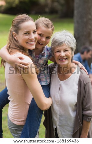 Portrait of grandmother, mother and daughter standing at the park