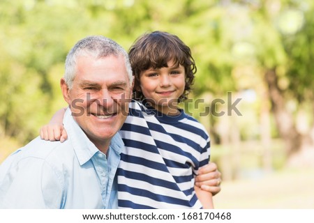 Portrait of a grandfather and son smiling in the park