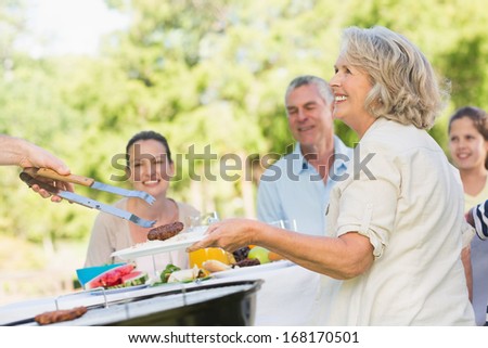 View of extended family dining at outdoor table