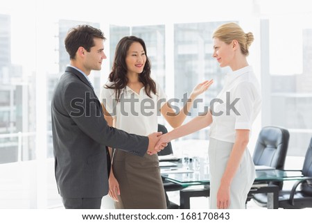 Businesswoman introducing colleagues in the office