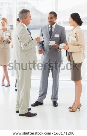Business people talking and drinking coffee at a conference in the office