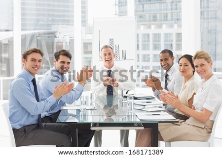 Business people clapping the camera at a meeting in the office