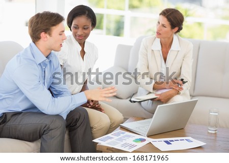 Business team meeting to go over numbers on the couch in the office