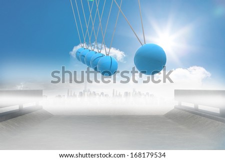 Newtons cradle above road to city