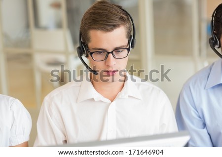 Male customer service agent with headset in call center