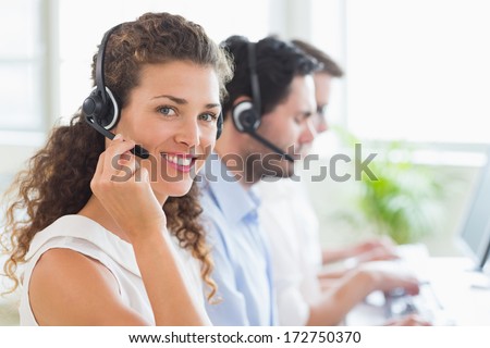 Portrait Of Confident Female Call Center Agent Working In Office