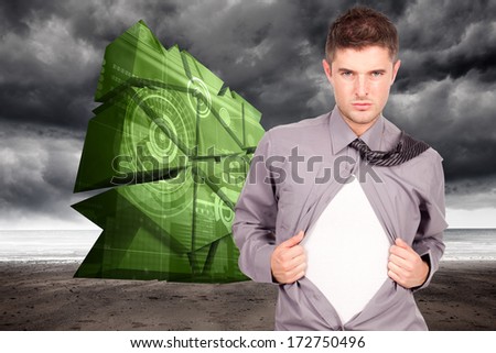 Young attractive man pulling at his shirt against stormy weather by the sea