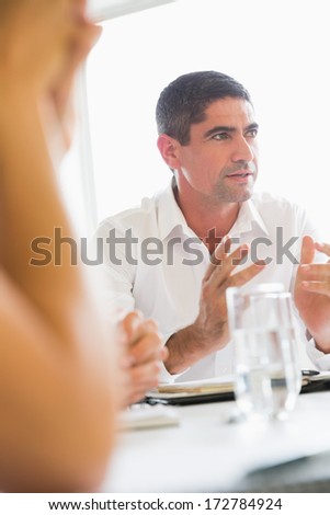 Confident businessman explaining strategy during meeting at office