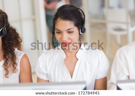 Female Customer Service Agent With Headset In Call Center