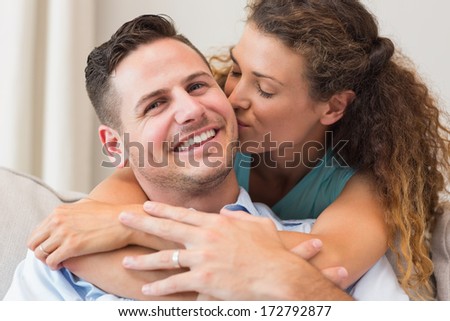 Loving Woman Kissing Man In Living Room