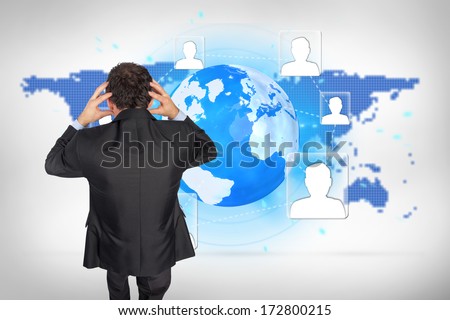 Stressed businessman with hands on head against blue world map on white background