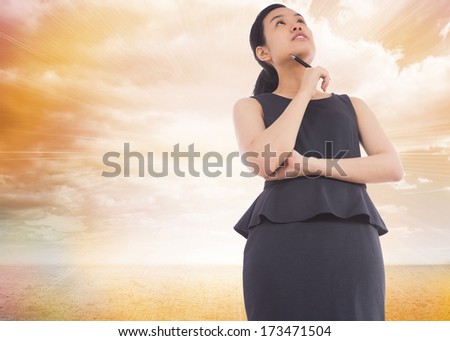Thinking asian businesswoman against blue sky seen through window