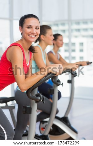 Side view portrait of fit young people working out at class in gym