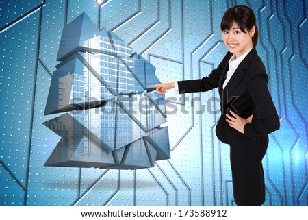 Smiling businesswoman pointing against circuit board on futuristic background