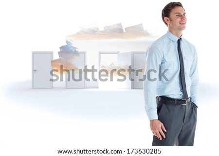 Smiling businessman standing with hand in pocket against colorful arrows in a desert landscape
