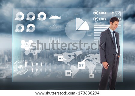 Happy businessman with hand in pocket against coastline and city